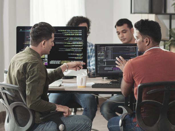 Developers working together on computers in the office