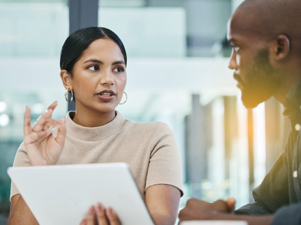 Business woman holding tablet review work with a team member at work.